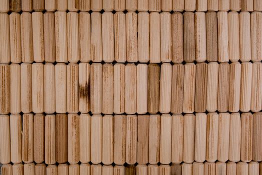 View of a grouping of wooden dowels as background. Close-up.