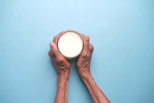 senior women hand holding a glass of milk ,