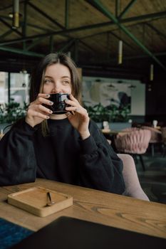 Woman enjoying her cup of tea coffee, hot beverage eyes opened