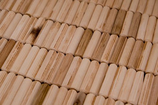 View of a grouping of wooden dowels as background. Close-up. Selective focus.