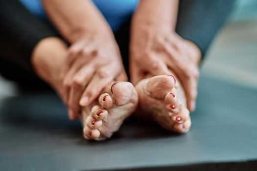 close-up. cropped image of an elderly woman sitting on a sports mat.