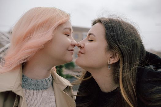 Happy young lesbian couple look on each other with love