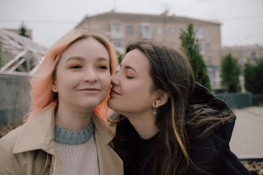 Happy young lesbian couple look on each other with love