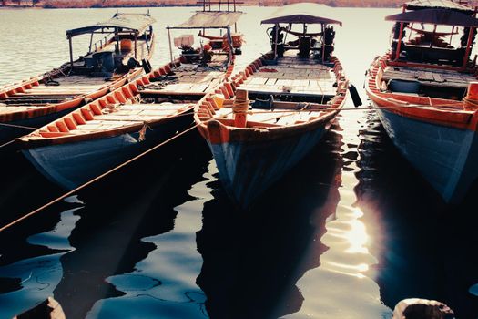 Traditional  Khmer fishing boats in a row moored in the harbor