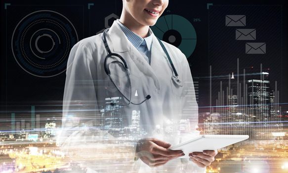 Close up of young medical industry employee standing against night city view and holding tablet in hands. Young female doctor using tablet. Double exposure with media interface icons