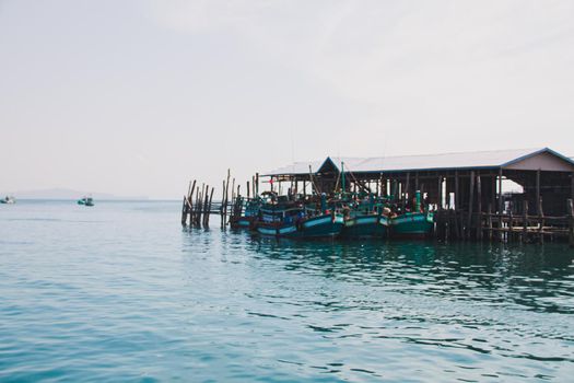 Minimalist scenery of the harbor against the blue sea and sky in Koh Sdach Island in Cambodia