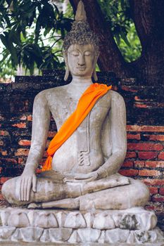 Buddha statue with a saffron sash at Wat Yai Chai Mongkhon temple in Ayutthaya, Thailand