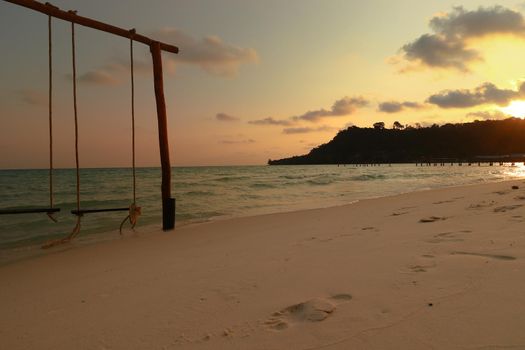 Romantic scene of a swing in the beach during sunset in Koh Rong Island, Cambodia