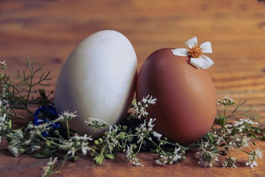 Close up of two Easter eggs in a nest of white dainty flowers