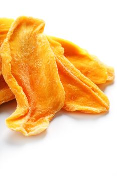 Dried sweet mango fruit slices as textural orange background in full screen