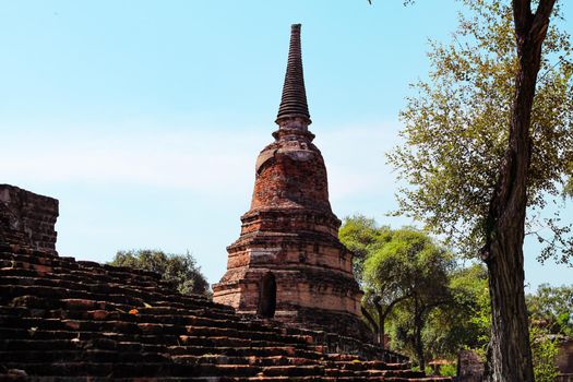 Majestic ancient ruins in Wat Mahathat inside the famous heritage site of Ayutthaya Historical Park in Thailand