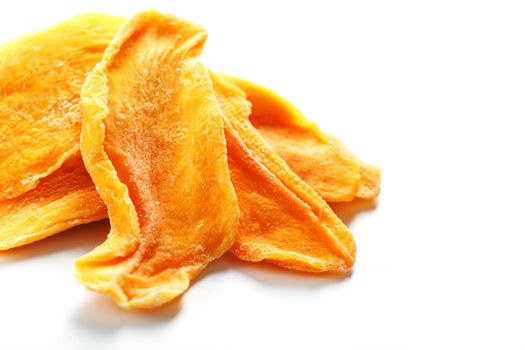 Dried sweet mango fruit slices as textural orange background in full screen