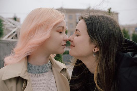 Happy young lesbian couple look on each other with love