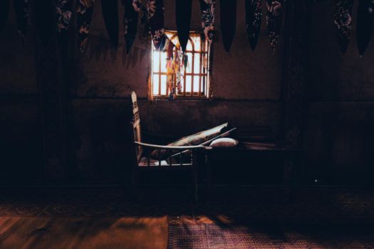 Creepy scenery of a chair inside a dark abandoned place
