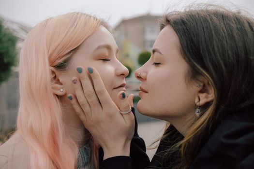 Happy young lesbian couple look on each other with love