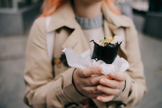 a woman holds shawarma in her hands. fast food. a simple and delicious snack. grilling.