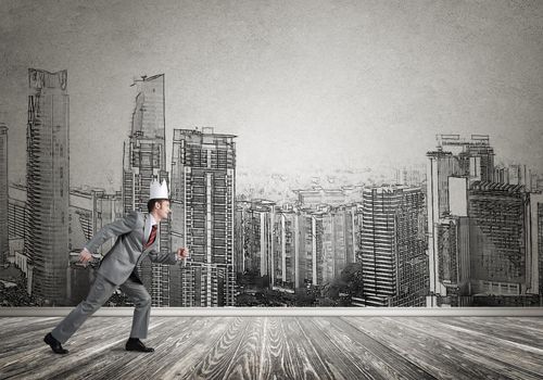 Young handsome businessman wearing white paper crown running in a hurry