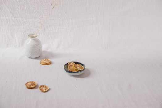 Dried lemon slices on a white delicate background showing the Spring and Summer aesthetics