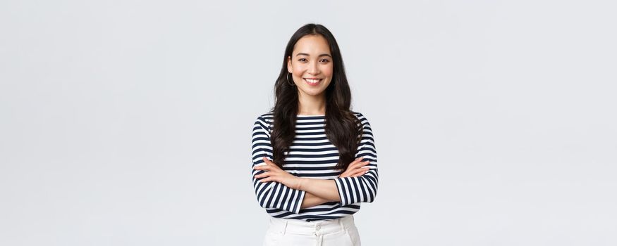 Lifestyle, people emotions and casual concept. Confident nice smiling asian woman cross arms chest confident, ready to help, listening to coworkers, taking part conversation.