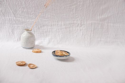 Dried lemon slices on a white delicate background showing the Spring and Summer aesthetics