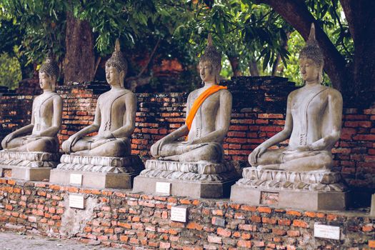 Row of Buddha statues at Wat Yai Chai Mongkhon temple in Ayutthaya, Thailand