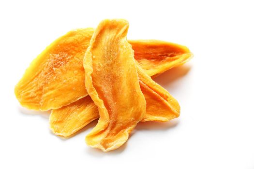 Dried sweet mango fruit slices as textural orange background in full screen