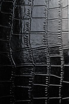 Black crocodile skin texture as background in full screen closeup