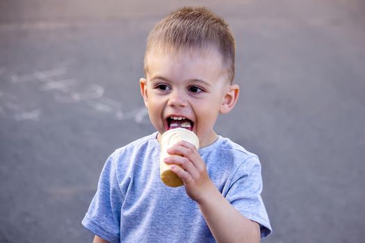 child eats ice cream in nature, ice cream in a cup. Nature. Selective focus