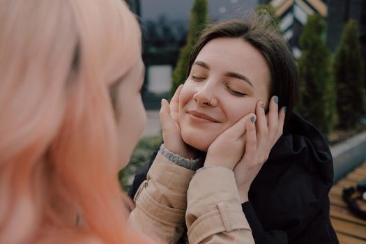 Happy young lesbian couple look on each other with love