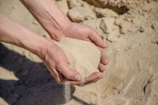 Man holding sand in his hands