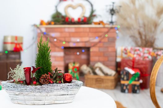 Close-up view of the Christmas reed that accompanies every Christmas. In the distance you can see the fireplace and the Christmas tree lights and the heart shape