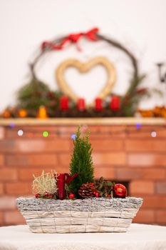 On the first one, ladies Christmas tablecloth and on the second one decorated fireplace for Christmas time