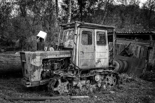 Old rusty tractor parked in the backyard