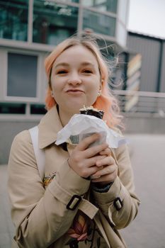 LGBT Lesbian woman eat sushi rolls on the walk asian cafe. street food