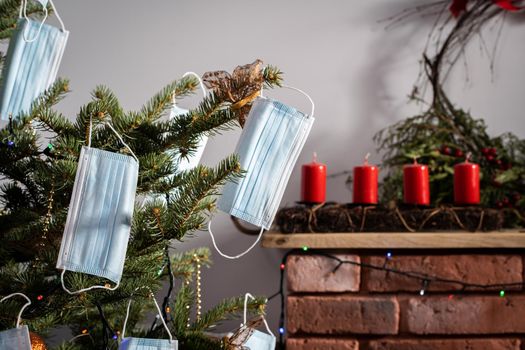 A Christmas tree in the foreground and a decorated fireplace in the second. Unusual Christmas.