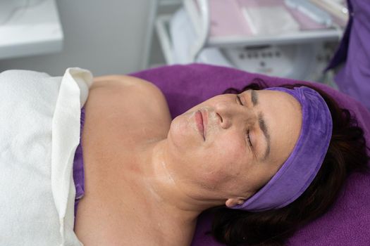 During cosmetic treatments, the client lies on the beauty bed waiting for the next treatment.