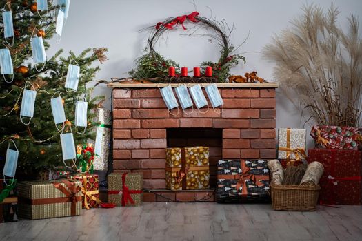 Gifts for the holidays lie under a decorated spruce tree in the large living room of the house. Family holidays despite the global COVID-19 viral disease.