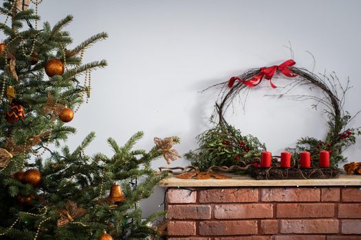 A Christmas tree in the foreground and a decorated fireplace in the second. Unusual Christmas.