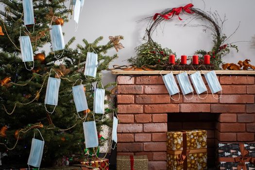 Gifts for the holidays lie under a decorated spruce tree in the large living room of the house. Family holidays despite the global COVID-19 viral disease.