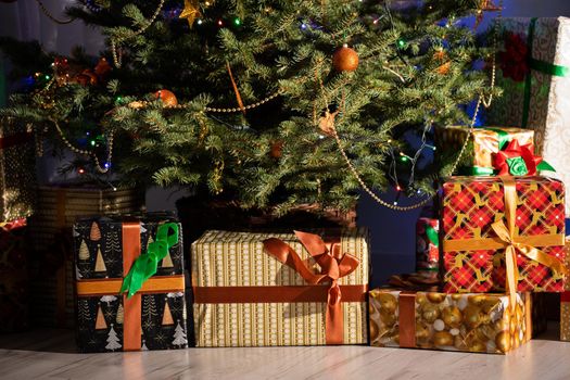 A Christmas tree in the foreground and a decorated fireplace in the second. Unusual Christmas.