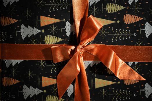 Prepared for giving a gift with a beautiful golden bow for a husband or wife on Christmas Day. Gift wrapped.