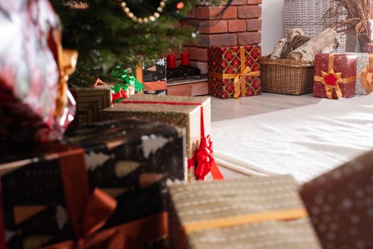 A Christmas tree in the foreground and a decorated fireplace in the second. Unusual Christmas.