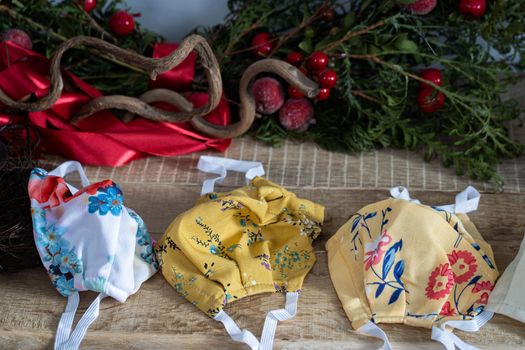 The fireplace is decorated with green coniferous branches and colorful protective masks in case you need to wear it during Christmas.