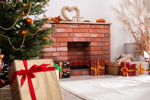 A Christmas tree in the foreground and a decorated fireplace in the second. Unusual Christmas.