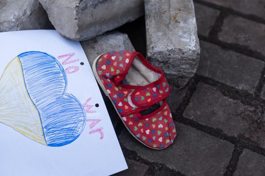 children's shoes and the flag of Ukraine, the war.