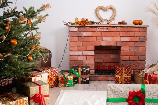 A Christmas tree in the foreground and a decorated fireplace in the second. Unusual Christmas.