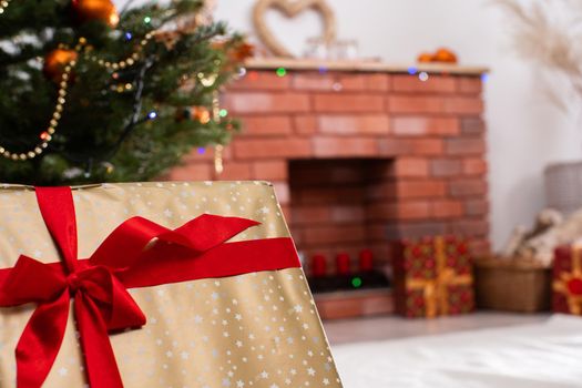 A Christmas tree in the foreground and a decorated fireplace in the second. Unusual Christmas.