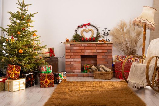 Living room in the house with Christmas tree and other decorations referring to Christmas. Room with a fireplace
