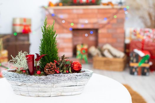 Close-up view of a Christmas reed decorated every Christmas. In the distance you can see the fireplace and Christmas tree lights and lots of presents