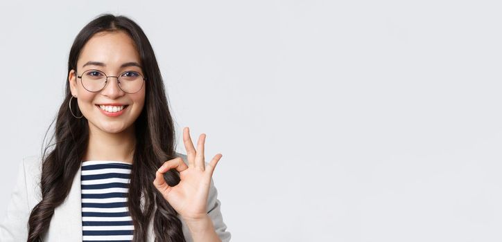 Business, finance and employment, female successful entrepreneurs concept. Close-up of professional real estate broker guarantee quality of her service, showing okay sign and smiling confident.